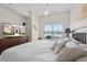 Primary bedroom with a TV, ceiling fan, and a window with a neighborhood view at 2200 San Vittorino Cir # 105, Kissimmee, FL 34741