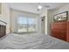 Cozy bedroom features a ceiling fan, large window, and a television atop a wooden dresser at 2200 San Vittorino Cir # 105, Kissimmee, FL 34741