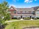 Well-maintained townhome featuring a neatly landscaped lawn and inviting front entrance at 2200 San Vittorino Cir # 105, Kissimmee, FL 34741