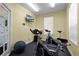 Bright fitness room equipped with exercise bikes, TV, and natural light at 2200 San Vittorino Cir # 105, Kissimmee, FL 34741