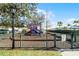 Community playground enclosed by a fence, featuring slides and climbing equipment for children at 2200 San Vittorino Cir # 105, Kissimmee, FL 34741