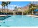Inviting swimming pool with lounge chairs and covered patio area with views of the surrounding landscaping at 2200 San Vittorino Cir # 105, Kissimmee, FL 34741