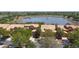 This aerial view showcases townhomes near a lake, offering a tranquil community setting at 2340 Palm Tree Dr, Kissimmee, FL 34759