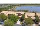 This aerial captures townhomes nestled along a serene lake, creating a picturesque community at 2340 Palm Tree Dr, Kissimmee, FL 34759