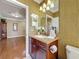 Half-bathroom with single vanity, dark wood cabinets and updated fixtures at 2340 Palm Tree Dr, Kissimmee, FL 34759