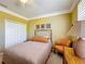 A charming bedroom featuring a wrought iron bed frame, complemented by stylish décor and ample closet space at 2340 Palm Tree Dr, Kissimmee, FL 34759