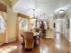 Inviting dining room with hardwood floors, a round table, and seamless access to the kitchen and entry at 2340 Palm Tree Dr, Kissimmee, FL 34759