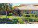 Exterior view of home featuring a screened patio, lush landscaping, and a well-maintained lawn at 2340 Palm Tree Dr, Kissimmee, FL 34759