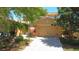 Charming single-Gathering home featuring a paved driveway and well-maintained landscaping and exterior at 2340 Palm Tree Dr, Kissimmee, FL 34759