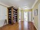 Hallway with decorative shelf display, wood floors and multiple doorways at 2340 Palm Tree Dr, Kissimmee, FL 34759