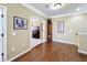 Hallway with hardwood floors leading to a living space with a fireplace at 2340 Palm Tree Dr, Kissimmee, FL 34759
