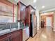 Kitchen with granite countertops, stainless steel appliances, and dark wood cabinetry at 2340 Palm Tree Dr, Kissimmee, FL 34759