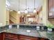 Open kitchen with granite countertops and breakfast bar overlooking the living area at 2340 Palm Tree Dr, Kissimmee, FL 34759