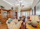 Cozy living room featuring hardwood floors, a ceiling fan, and a large window with natural light at 2340 Palm Tree Dr, Kissimmee, FL 34759