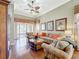 Comfortable living room with hardwood floors, floral print furniture, and outdoor access through glass doors at 2340 Palm Tree Dr, Kissimmee, FL 34759