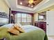 Bright main bedroom with tray ceilings, dresser, and a large window providing ample natural light at 2340 Palm Tree Dr, Kissimmee, FL 34759