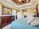Elegant main bedroom featuring a tray ceiling, dark wood dresser, and an en-suite bathroom at 2340 Palm Tree Dr, Kissimmee, FL 34759