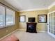 Relaxing office space with a decorative fireplace and a window with shutters, creating a cozy atmosphere at 2340 Palm Tree Dr, Kissimmee, FL 34759