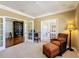 Inviting home office with a comfortable chair, a warm lamp, and ample lighting from the French doors at 2340 Palm Tree Dr, Kissimmee, FL 34759