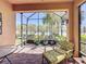Relaxing screened patio with brick flooring offers serene views and comfortable seating at 2340 Palm Tree Dr, Kissimmee, FL 34759