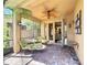 Charming screened patio with comfortable seating, ceiling fan, and outdoor dining area at 2340 Palm Tree Dr, Kissimmee, FL 34759