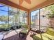 Relaxing screened patio with brick flooring offers peaceful views and comfortable seating at 2340 Palm Tree Dr, Kissimmee, FL 34759