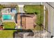 Aerial view of a home with a private pool, well-manicured lawn, and a detached garage at 2566 Conway Gardens Rd, Orlando, FL 32806