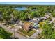 Idyllic neighborhood featuring well-maintained homes, lush greenery, and a serene lake in the background at 2566 Conway Gardens Rd, Orlando, FL 32806