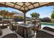 Inviting backyard patio featuring comfortable seating, a stylish pergola, and a sparkling swimming pool, perfect for relaxation at 2566 Conway Gardens Rd, Orlando, FL 32806