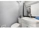 Small bathroom featuring a white vanity, toilet and small mirror at 2566 Conway Gardens Rd, Orlando, FL 32806