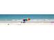 A sunny beach scene with a colorful beach umbrella in the frame at 2566 Conway Gardens Rd, Orlando, FL 32806