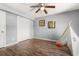 Cozy bedroom with hardwood floors, ceiling fan, a play teepee, and ample closet space at 2566 Conway Gardens Rd, Orlando, FL 32806