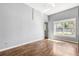 Bedroom featuring hardwood floors, ceiling fan, and a large window allowing ample natural light at 2566 Conway Gardens Rd, Orlando, FL 32806