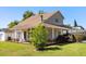 Inviting two-story home featuring a covered front porch, manicured lawn, and lush landscaping at 2566 Conway Gardens Rd, Orlando, FL 32806
