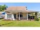 Charming single-story home with a welcoming front porch, landscaped garden, and a well-maintained lawn at 2566 Conway Gardens Rd, Orlando, FL 32806