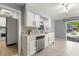 Well-lit kitchen featuring modern appliances, ample counter space, and white cabinets at 2566 Conway Gardens Rd, Orlando, FL 32806