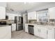 Modern kitchen with white cabinets, stainless steel appliances, and beautiful tile backsplash at 2566 Conway Gardens Rd, Orlando, FL 32806