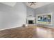 Bright living room features a fireplace, hardwood floors, and a large window providing great natural light at 2566 Conway Gardens Rd, Orlando, FL 32806