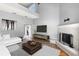 Bright living room with high ceilings, modern decor, fireplace, and hardwood floors at 2566 Conway Gardens Rd, Orlando, FL 32806
