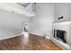 Bright living room with high ceilings, modern decor, fireplace, and hardwood floors at 2566 Conway Gardens Rd, Orlando, FL 32806
