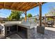 Outdoor kitchen featuring a sink, prep area and string lights at 2566 Conway Gardens Rd, Orlando, FL 32806