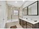 Bright bathroom featuring a double vanity, tub, and a separate shower with glass door at 2619 Corvette Ln, Kissimmee, FL 34746