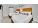 A guest bedroom featuring two twin beds, soft bedding, and a large window at 2619 Corvette Ln, Kissimmee, FL 34746