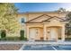 Charming two-story townhome featuring a red tile roof, paired entryways, and vibrant yellow stucco facade at 2619 Corvette Ln, Kissimmee, FL 34746