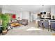Open-concept living area with stylish furnishings, tile floors, and a seamless flow to the kitchen and dining area at 2619 Corvette Ln, Kissimmee, FL 34746