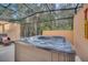 A hot tub enclosed in a screened-in patio for an relaxing outdoor experience at 2619 Corvette Ln, Kissimmee, FL 34746