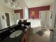 Bright bathroom with a soaking tub, separate shower, double vanity, and a private toilet area at 2677 Emerald Island Blvd, Kissimmee, FL 34747