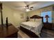 Comfortable bedroom features wood furnishings, patterned bedding, and neutral green walls at 2677 Emerald Island Blvd, Kissimmee, FL 34747