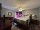 Charming bedroom features wood furnishings, chevron bedding, and modern ceiling fan at 2677 Emerald Island Blvd, Kissimmee, FL 34747