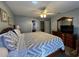 Well-lit bedroom featuring a wood dresser, comfortable bed, and neutral decor at 2677 Emerald Island Blvd, Kissimmee, FL 34747